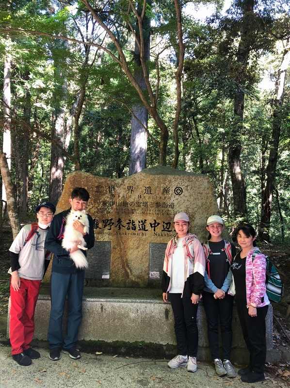 熊野古道中辺路の世界遺産石碑の前でツアー参加のご家族